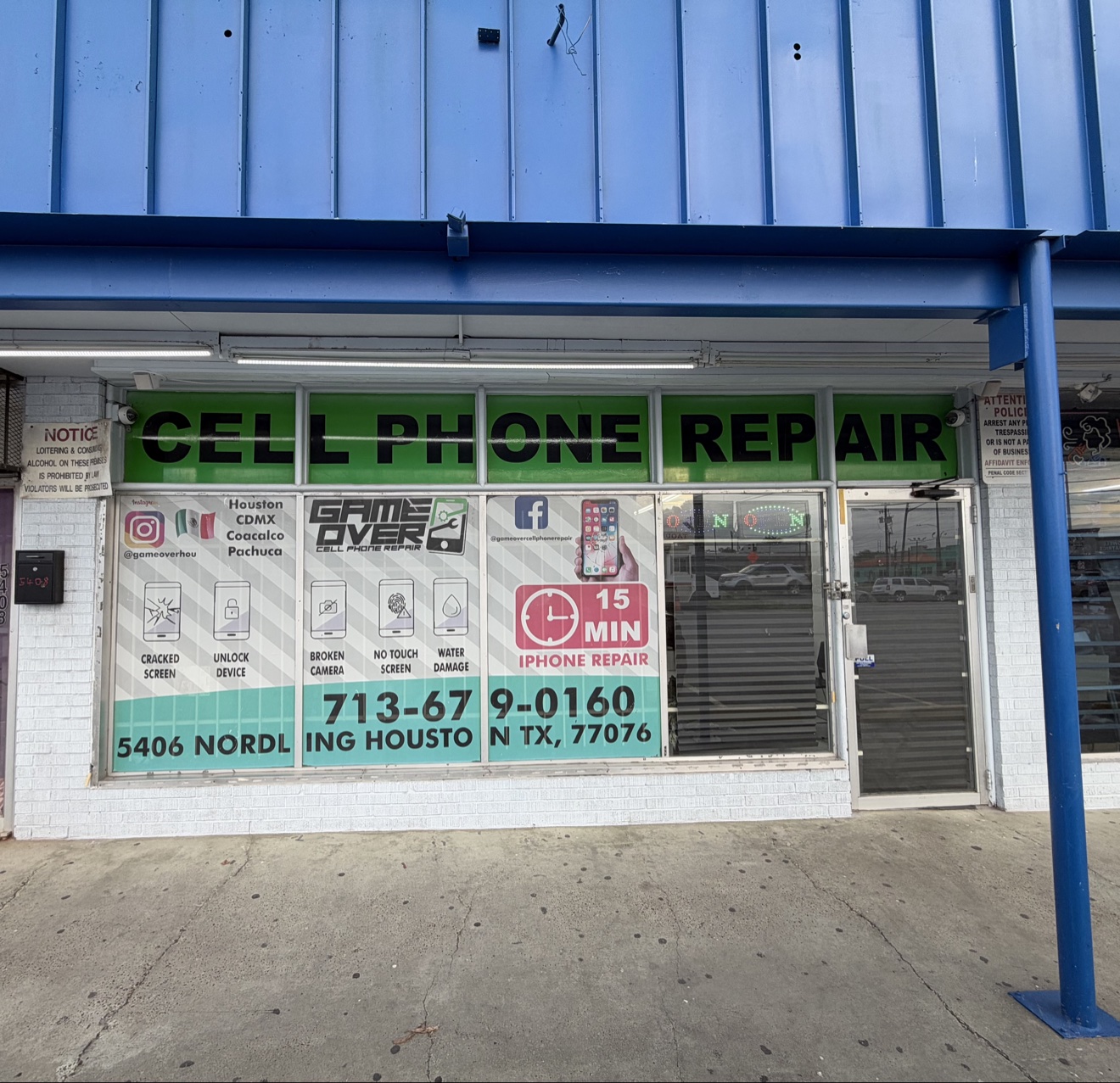 The Game Over storefront at 5406 Nordling Rd, Houston, TX 77076, with “Cell Phone Repair” in green letters over the windows and the shop phone number on the glass